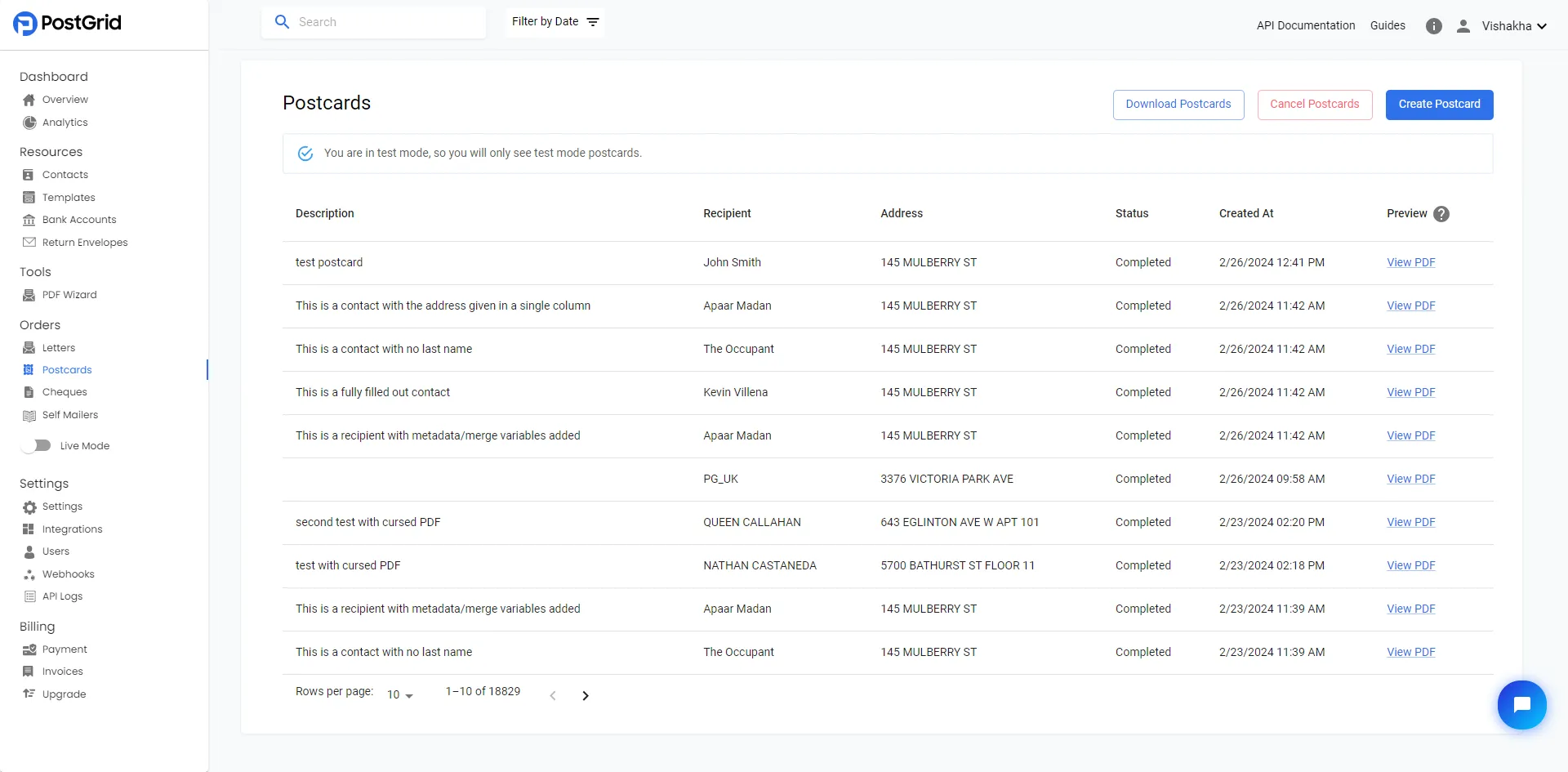 Postcards order list page with all existing postcard orders and a Create Postcard button in the top-right corner